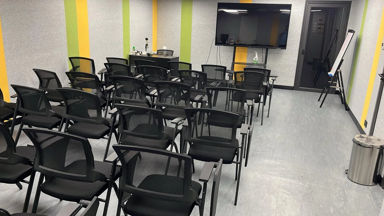 Easy Solution Training Room — open floor plan, classroom layout, signature green and yellow ribbon walls